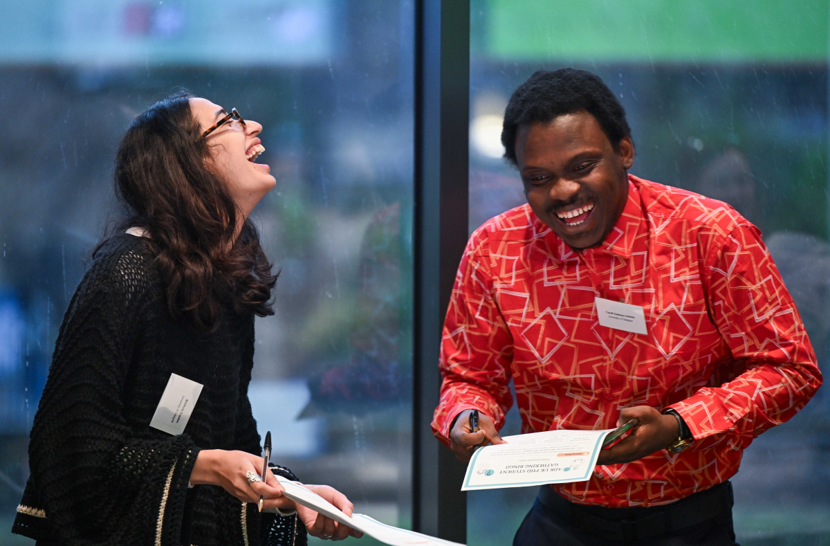 Two students laughing together